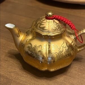 Gold Teapot with Dragons and a braided Red Cord Accent